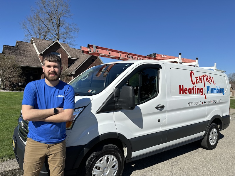 Central Heating and Plumbing technician standing by his work van Central Heating and Plumbing technician standing by his work van